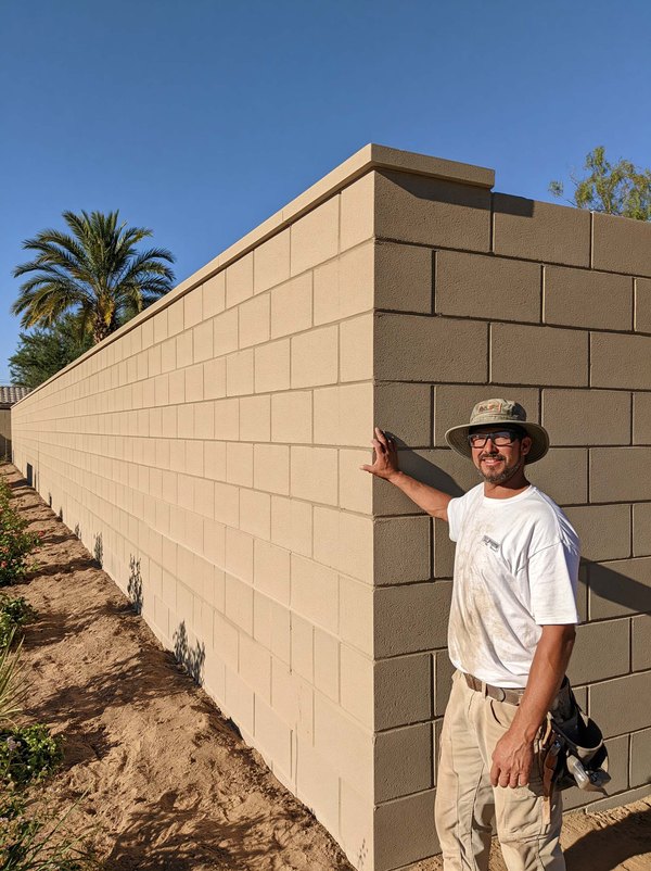 A finished block wall standing along the back of a desert yard