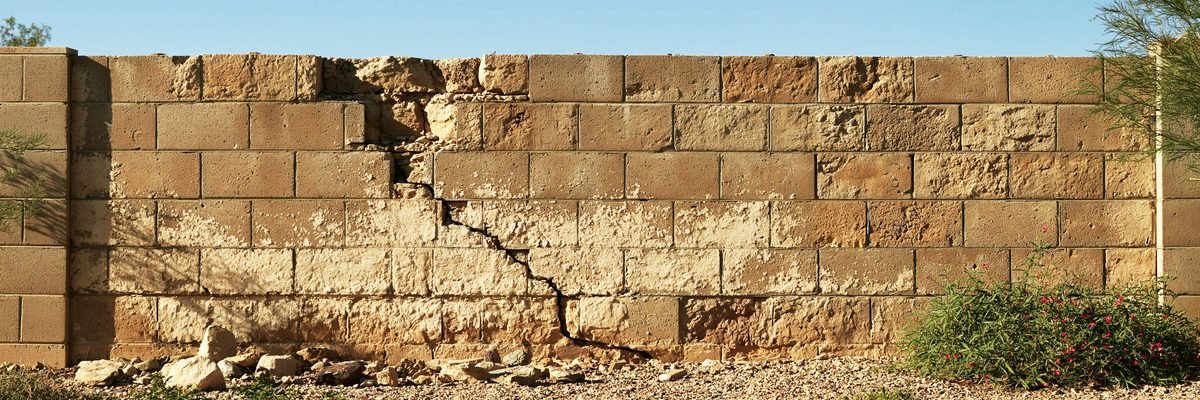 A cracked and leaning section of block wall on a Queen Creek property.